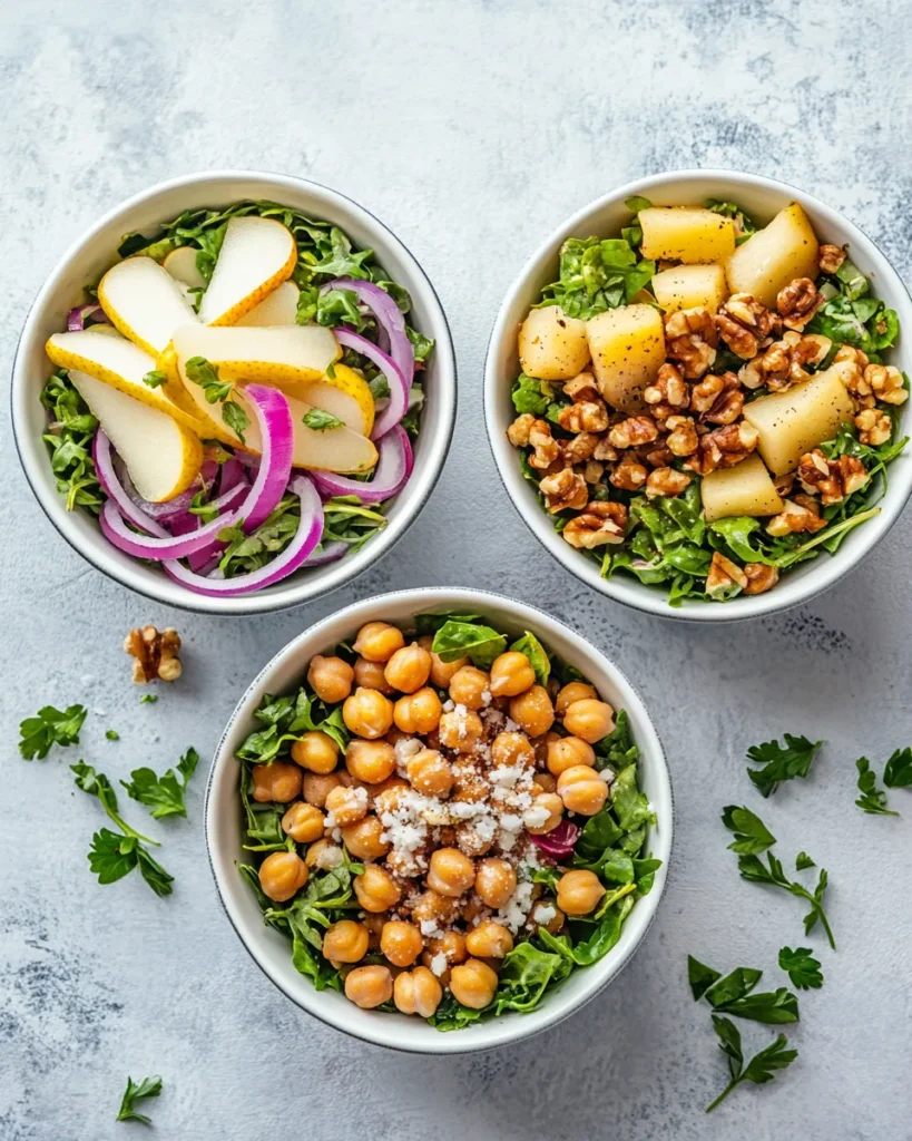 Three variations of apple feta chicken salad with different toppings and ingredients in separate bowls